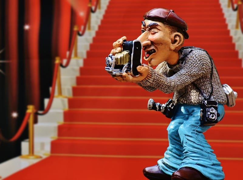 Paparazzi taking photos of a celebrity